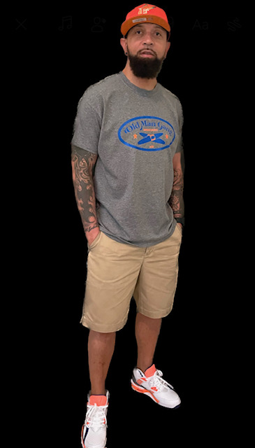 A man standing in front of the camera wearing shorts and a t-shirt.